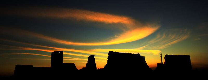Main image: Sunset illuminates wispy clouds over the remains of a major ancient building complex known as the 'Barracks' in January, 2010.
